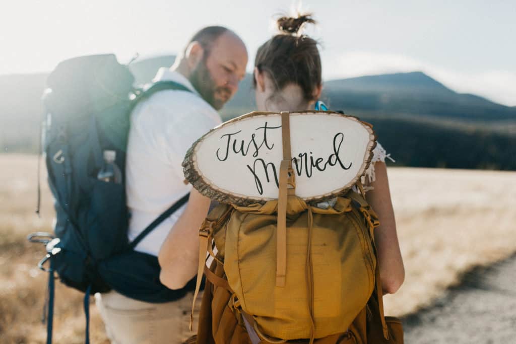 Couple wearing backpacks on their hiking elopement