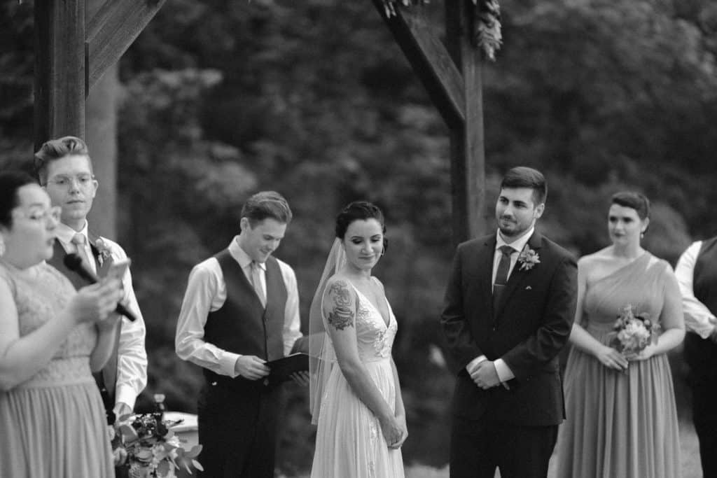 A couple surrounded by friends and loved-ones during their small wedding ceremony. 