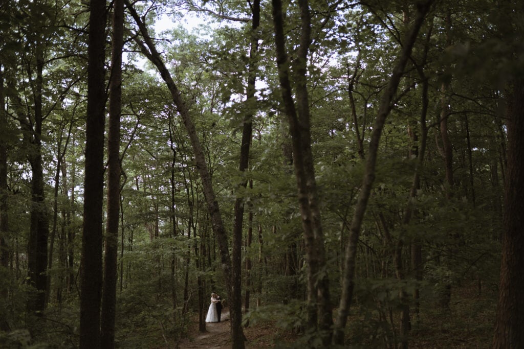 A bride and groom in the forest hugging each other at Cloudland Canyon State Park. 