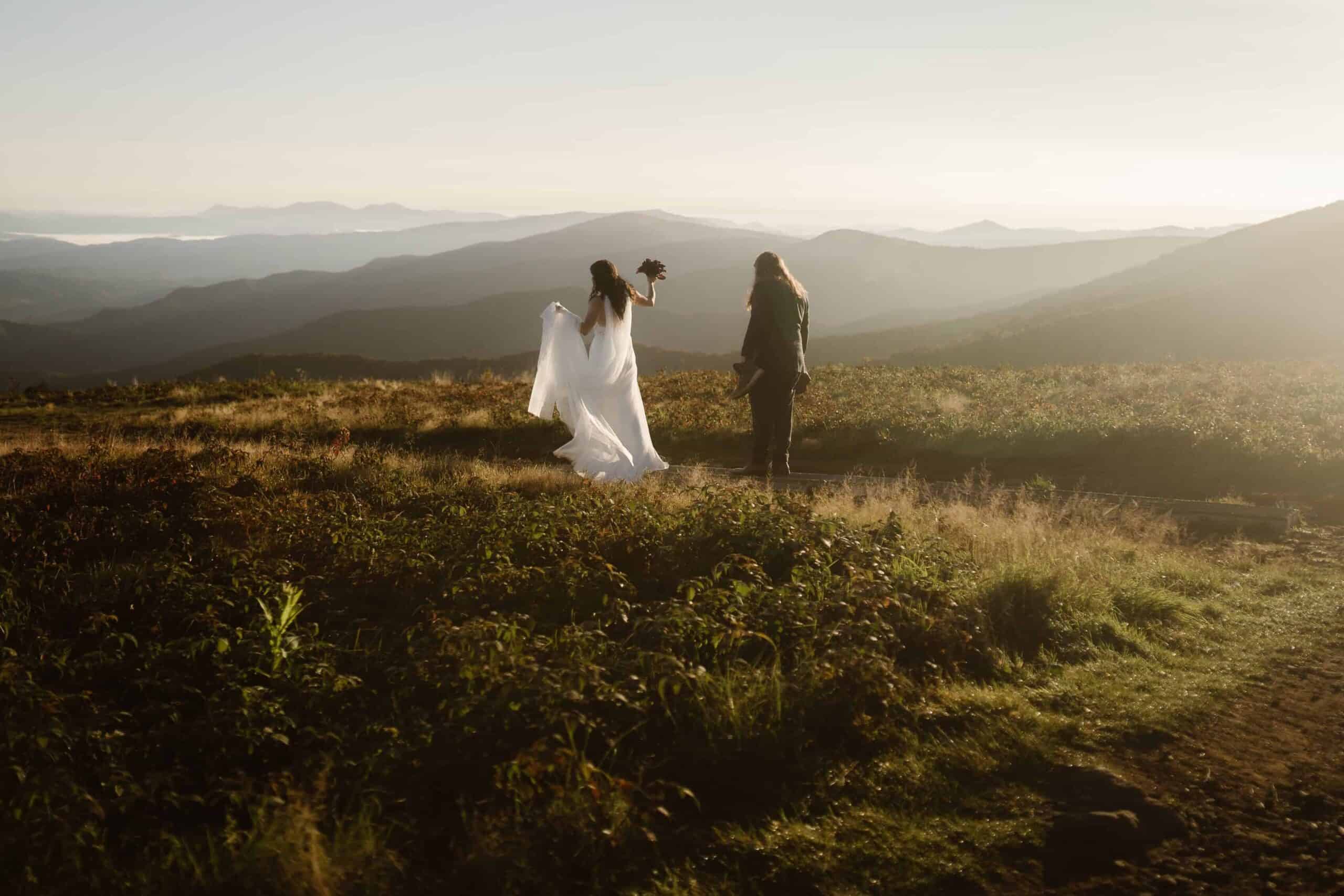 A bride and groom adventuring for their sunrise mountain hiking elopement in North Carolina