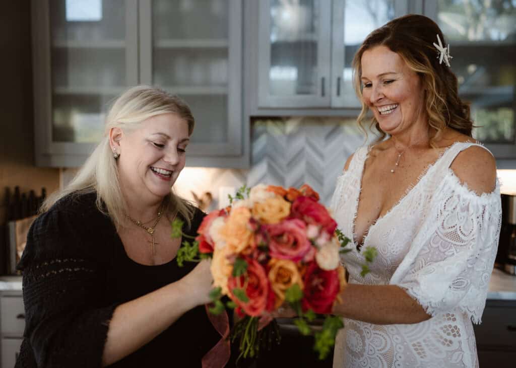Two people working on a wedding bouquet together. 