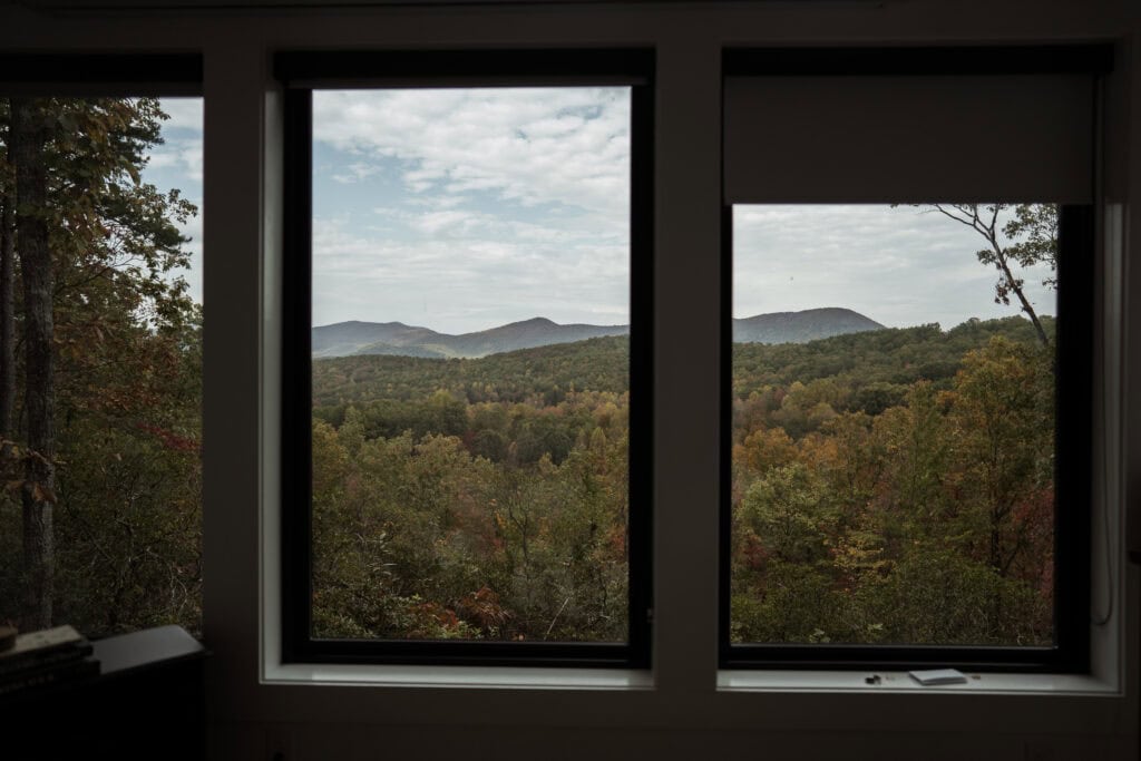 A new of the mountains of North Georgia through the windows of a cabin. 
