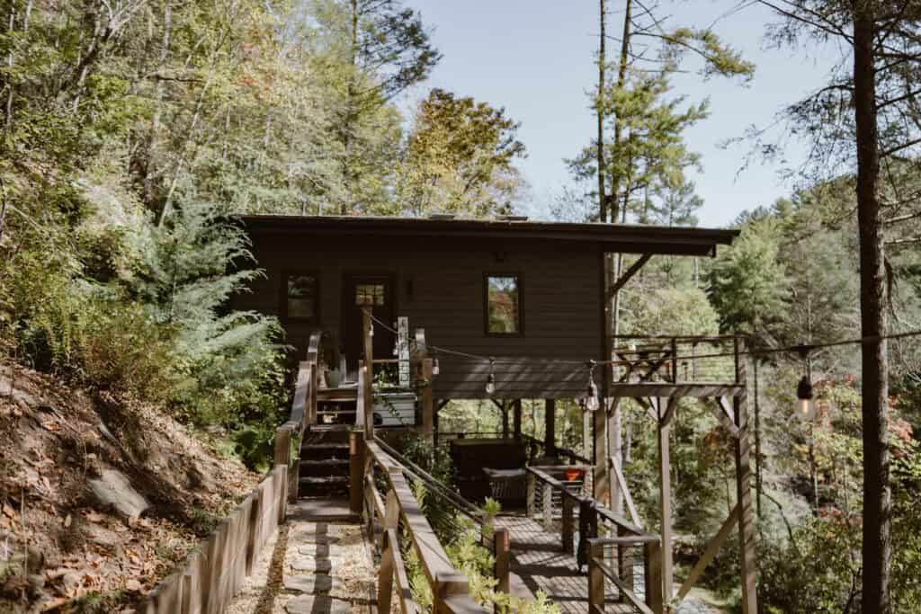 A photo of an Airbnb surrounded bye trees. 