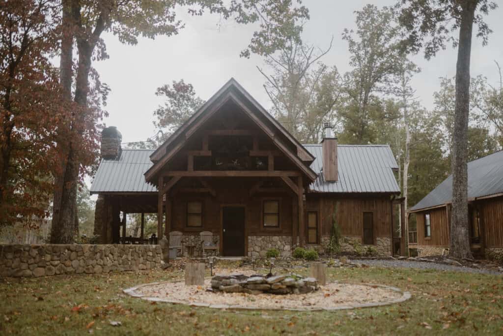 A view of an old and rustic cabin rental with stone and warm wood tones. 