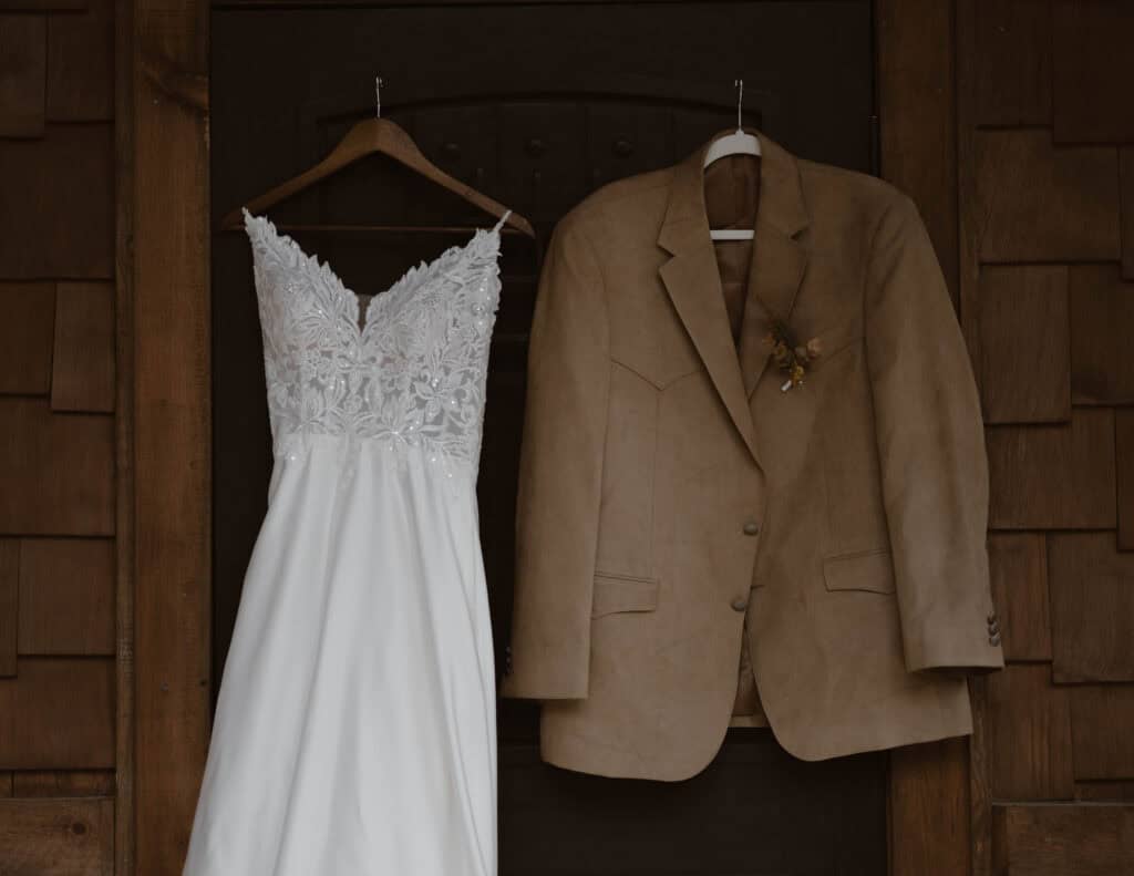 Wedding attire hanging on a doorframe. 